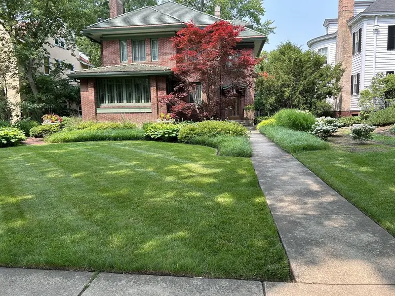 Green lawn and front walkway leading to a home in Evanston, IL