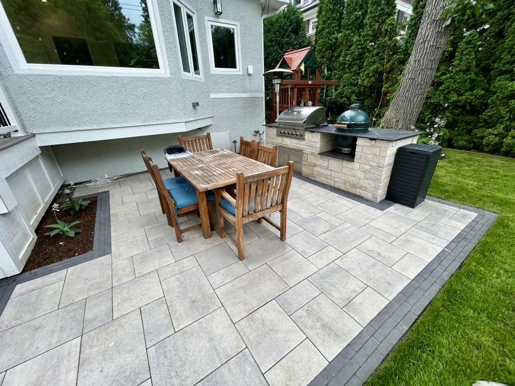 Outdoor kitchen and dining area on a new paver patio