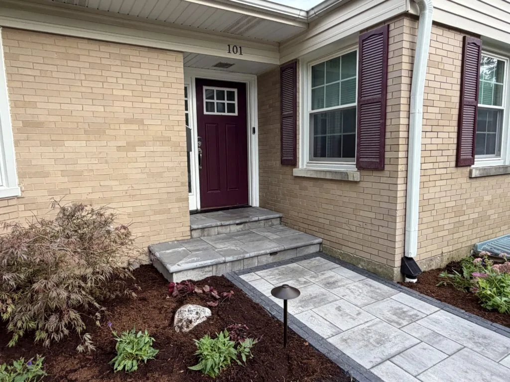 New paver walkway and front steps with fresh landscaping